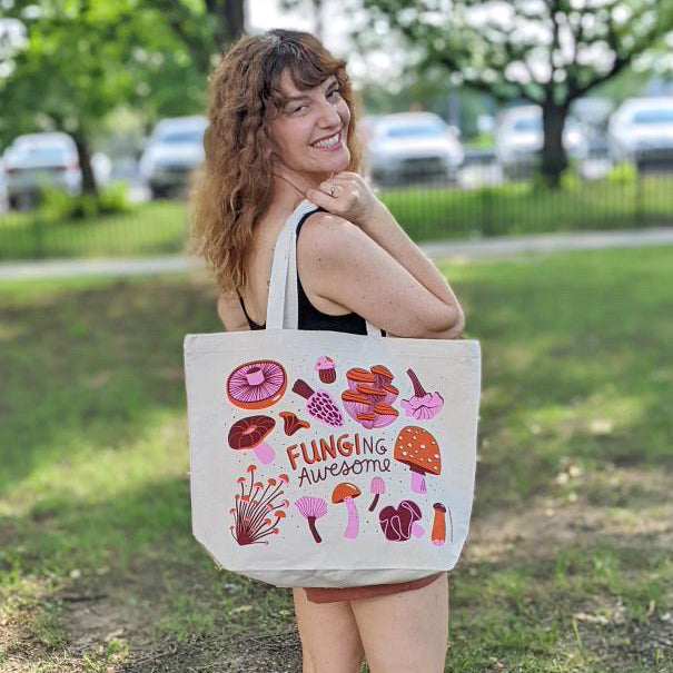 Neighborgoods founder, Jodi, carrying mushroom tote in a park