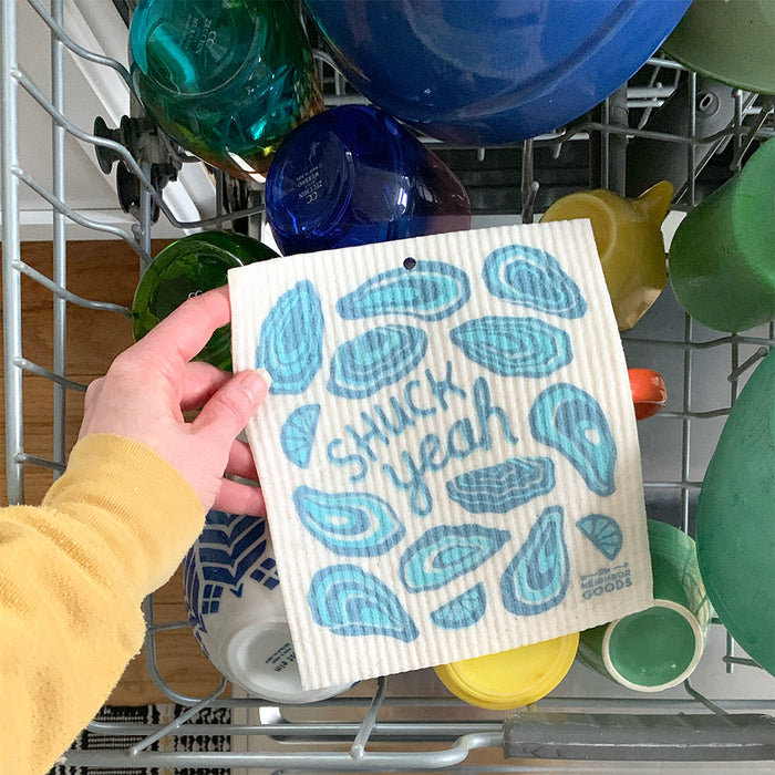 A oyster sponge cloth is placed on the top rack of the dishwasher.