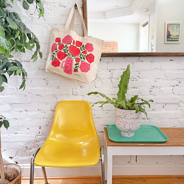 A Roses tote bag hangs on a nail in the entryway.