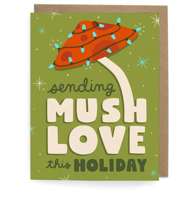 Olive green card with mushroom and string lights design, featuring the phrase "Sending mush love this holiday," with a brown envelope