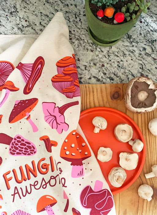 Mushroom towel photographed with mushrooms on a kitchen counter and cutting board