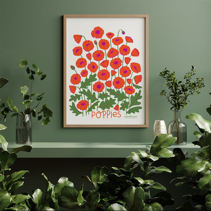 Poppies print in large size framed amongst sveral houseplants
