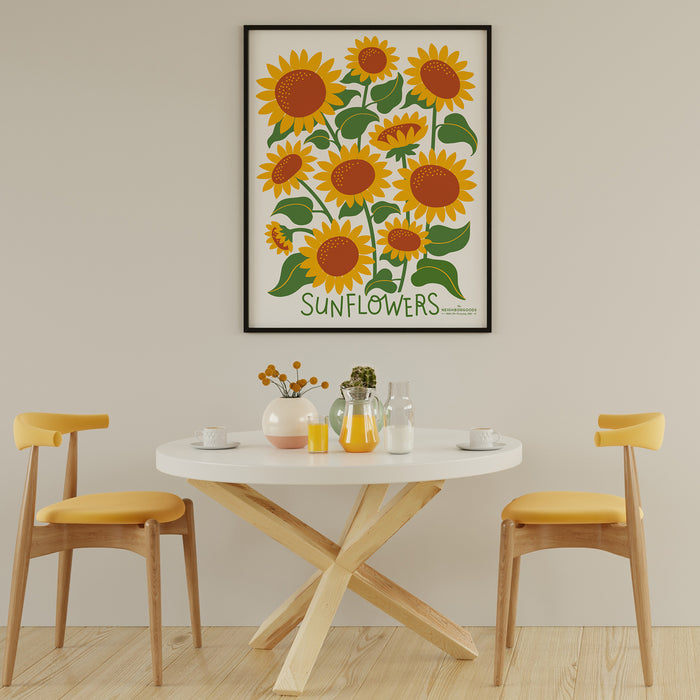 Sunflower print in large size, framed above a small breakfast table and chairs