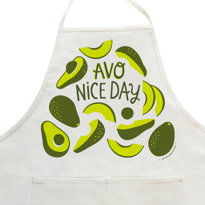 Close-up on white apron with avocado design, featuring the phrase "Avo nice day"