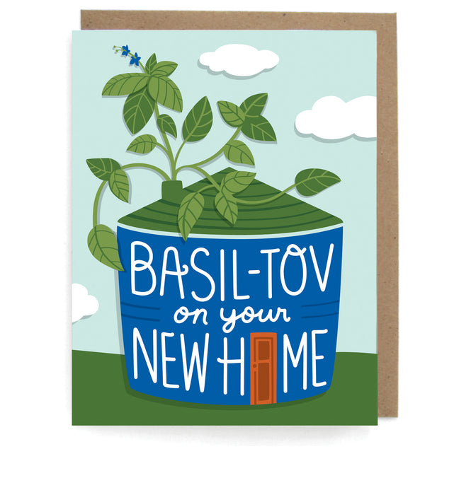 Card that pictures a basil plant home design set against a blue sky with clouds, featuring the phrase "Basil-tov on your new home," with a brown envelope