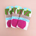 Front view of three beet kitchen dish towels packaged in branded belly band sleeves
