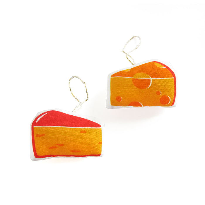 "Both sides of soft ornament of a cheese wedge "