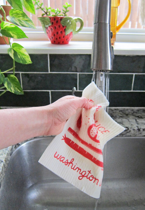 DC sponge cloth being put under running water in a sink