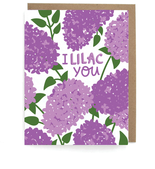 White card with lilacs design, featuring the phrase "I lilac you," with a brown envelope