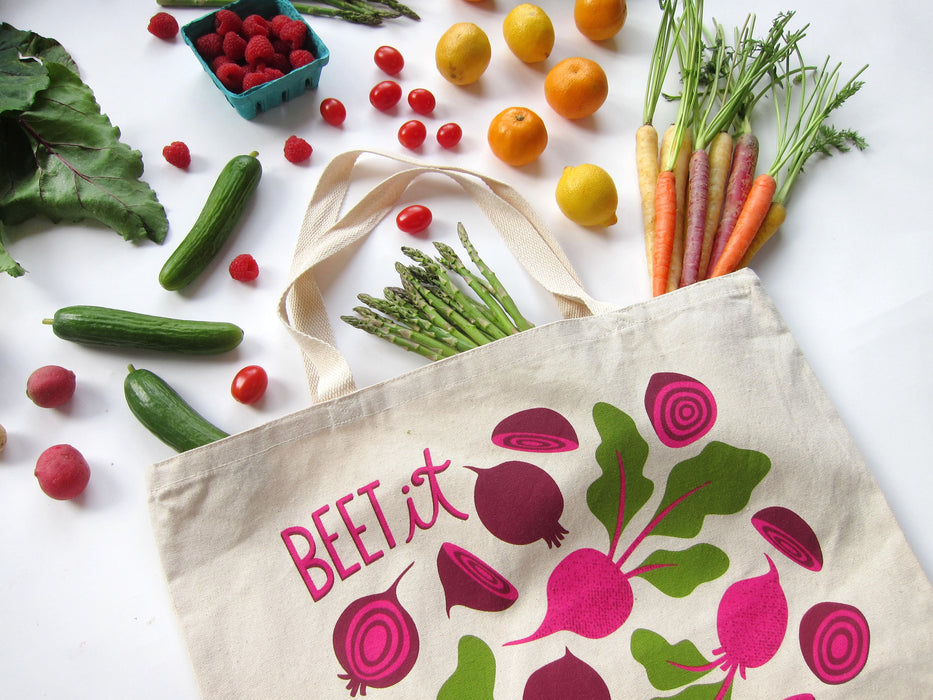 Beets tote bag photographed at an angle with an array of produce