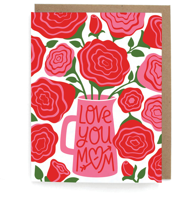 White card that pictures red and pink roses in a vase, featuring the phrase "Love you mom," with a brown envelope