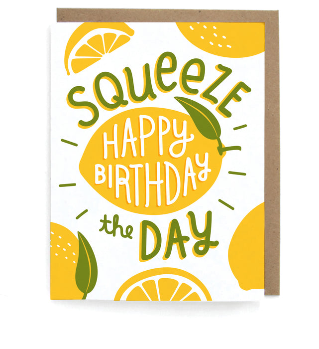 White card with lemon design, featuring the phrase "Squeeze the day;Happy birthday," with a brown envelope