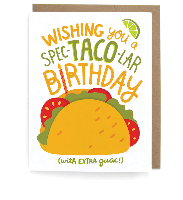 White card that pictures a taco and a slice of lime, featuring the phrase "Wishing you a spec-TACO-lar birthday (with extra guac)," with a brown envelope