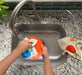 Basil sponge cloth being used to clean dishes in a sink