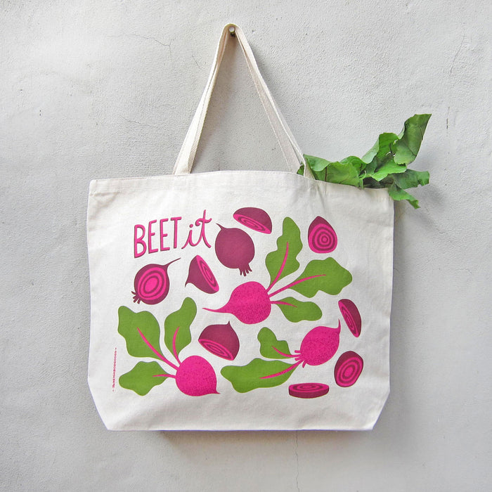 Beet tote holding produce, hanging on a wall