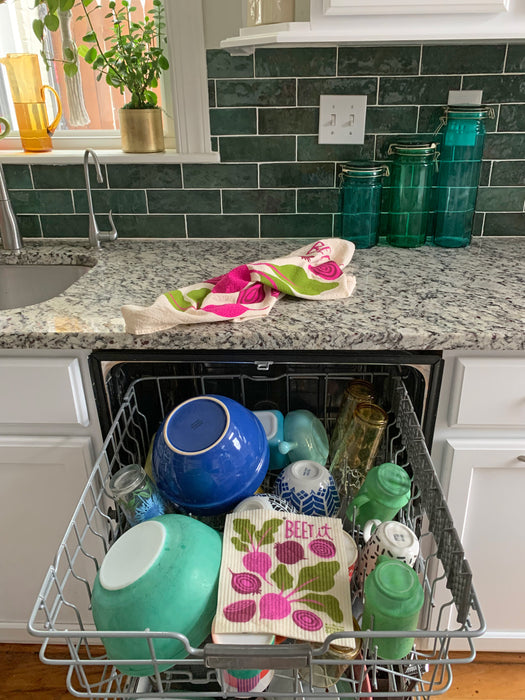 Beet sponge cloth placed in the top rack of a dishwasher to be cleaned