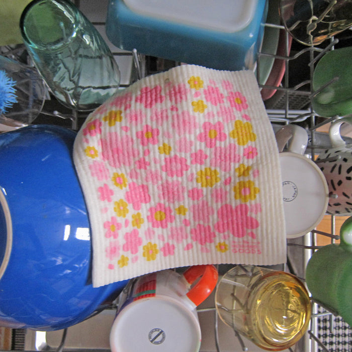 Blossom sponge cloth placed in the top rack of a dishwasher to be cleaned