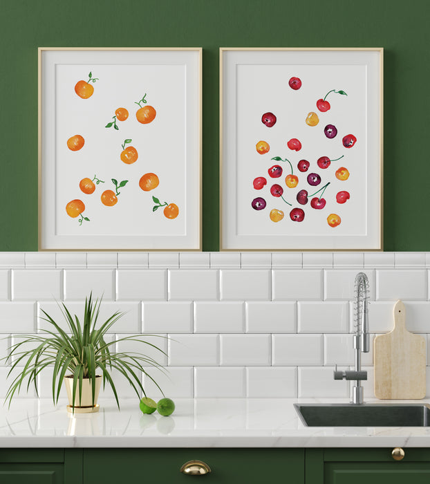 Watercolor Cherries and Watercolor Clementines prints framed above a kitchen sink