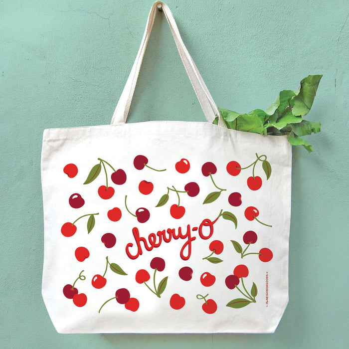 Cherries tote holding produce, hanging on a wall