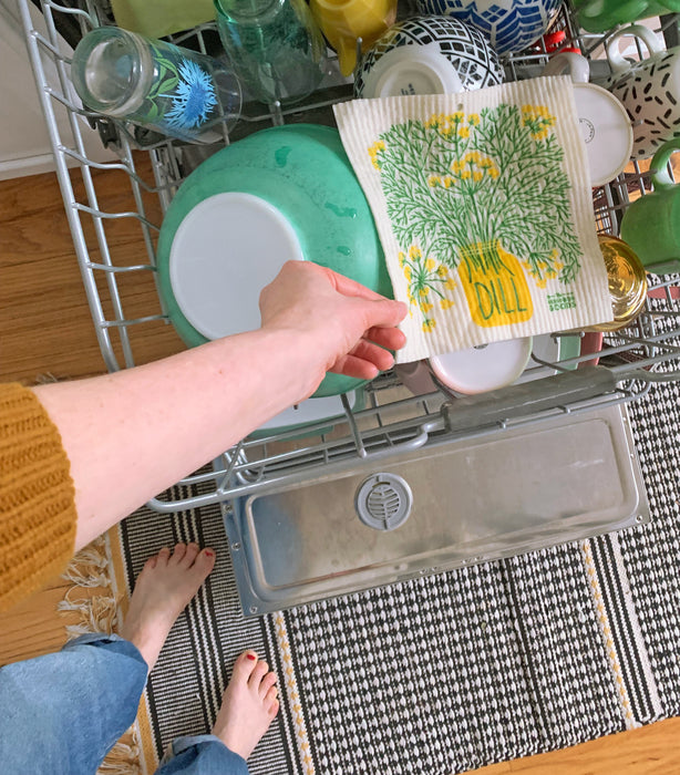 Dill sponge cloth placed in the top rack of a dishwasher to be cleaned