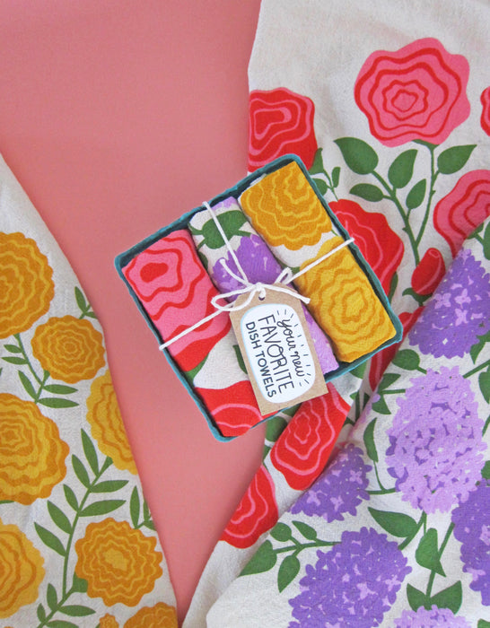 Edible flowers dish towel set photographed with marigold, rose, and lilac dish towels