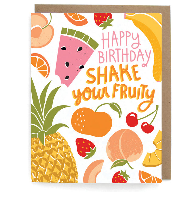 White card that pictures avariety of fruits, featuring the phrase "Happy birthday; Shake your fruity," with a brown envelope