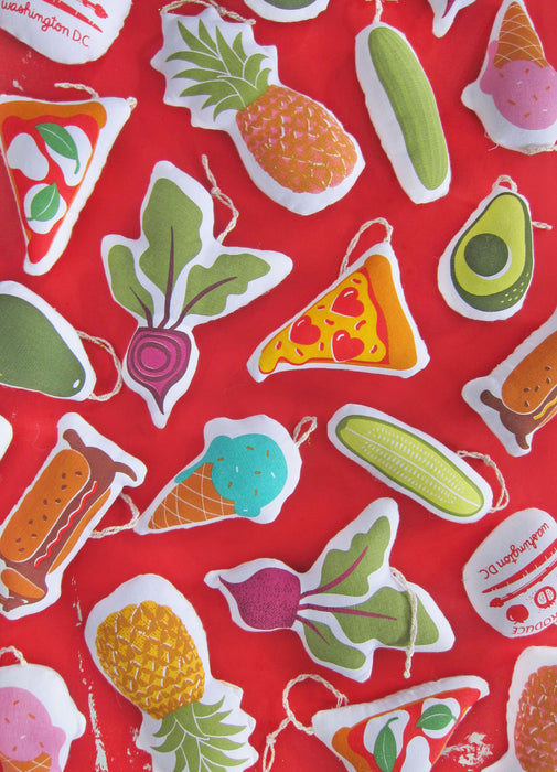 Ice cream ornament pictured with an array of other Neighborgoods holiday ornaments