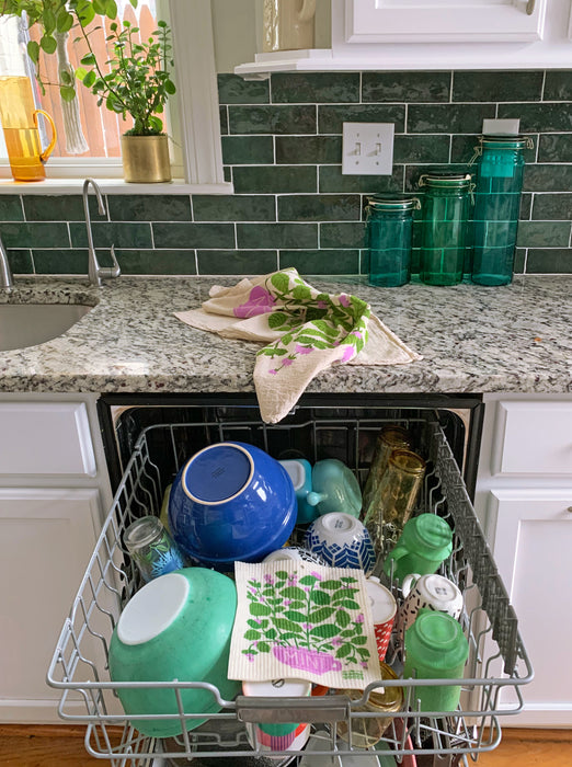 Mint sponge cloth placed in the top rack of a dishwasher to be cleaned