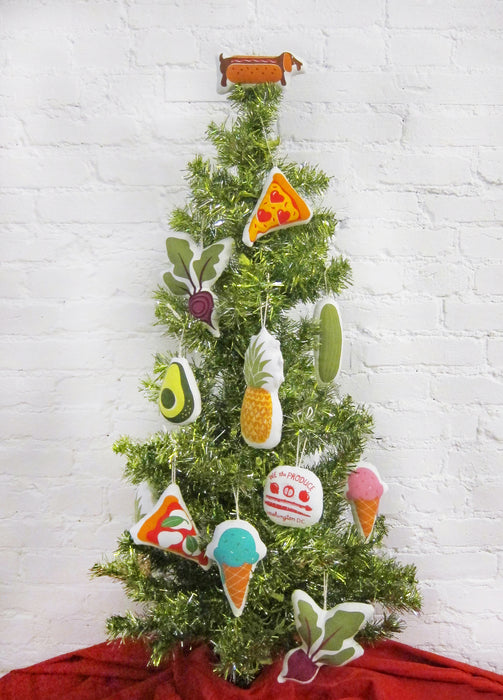 Hot dog ornament pictured on top of a small tree with an array of other Neighborgoods holiday ornaments