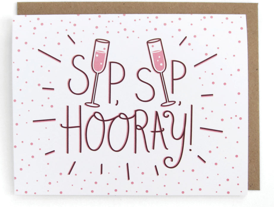 White card with pink bubbly drink design, featuring the phrase "Sip sip hooray," with a brown envelope