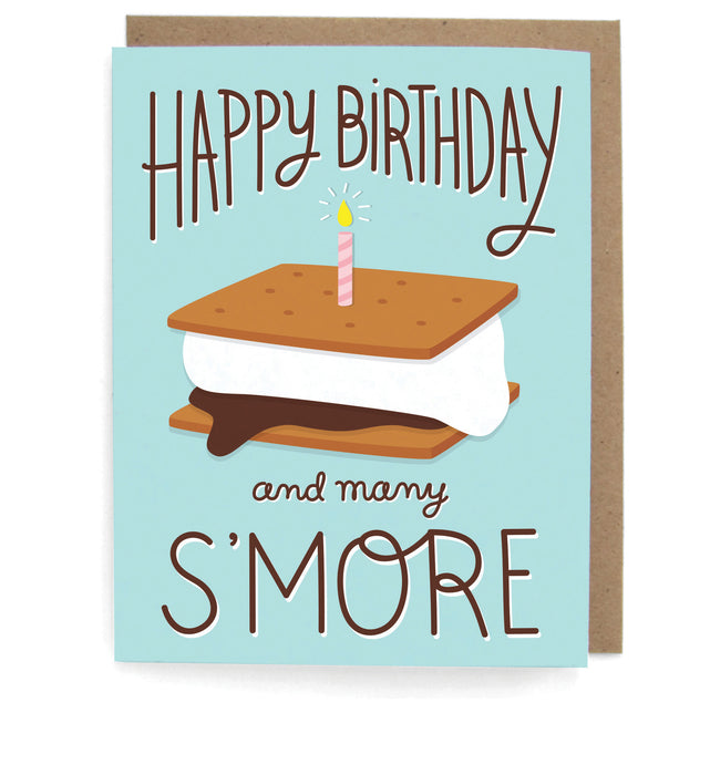 Light blue card that pictures a s'more with a lit pink candle, featuring the phrase "Happy birthday and many s'more," with a brown envelope
