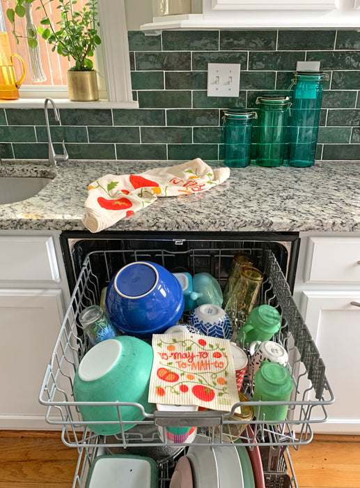 Tomato sponge cloth placed in the top rack of a dishwasher to be cleaned