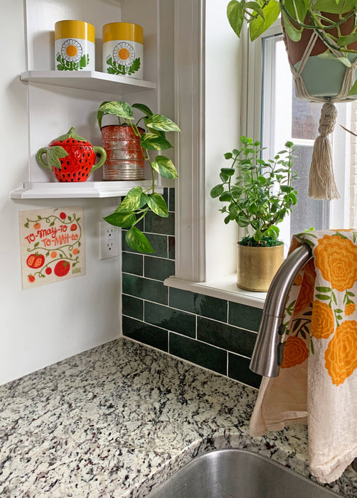 Tomato sponge cloth hung up by the kitchen sink