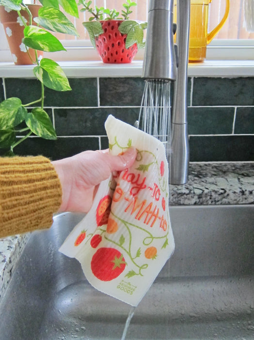 Tamoto sponge cloth being put under running water in a sink