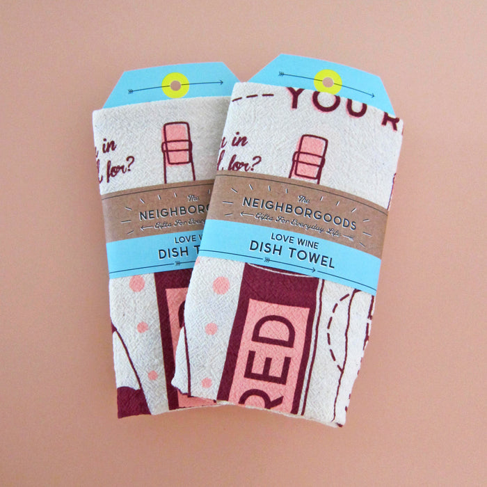 Front view of two wine dish towels individually packaged  in branded belly band sleeves