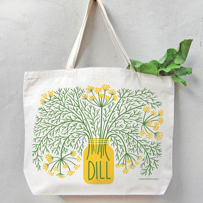 Dill tote bag filled with green leafy produce, with the greens peeking out from the top.