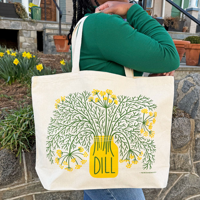 A woman carrying the Dill tote bag over her shoulder.