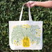 A woman holds a Dill tote bag.