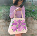 A woman reaches inside the Lilac tote bag.