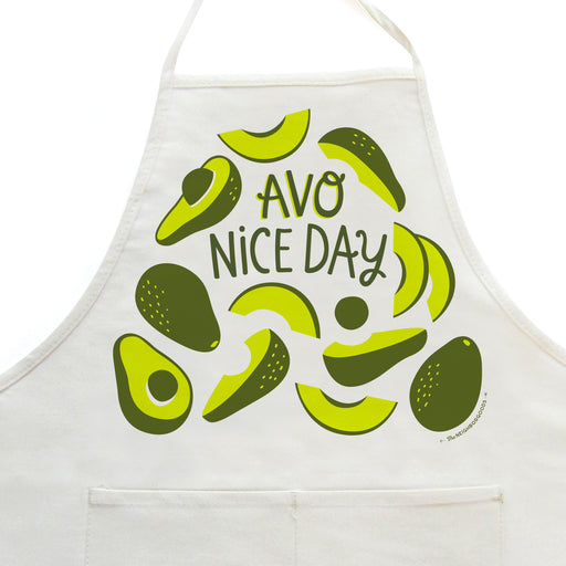 Close-up on white apron with avocado design, featuring the phrase "Avo nice day"