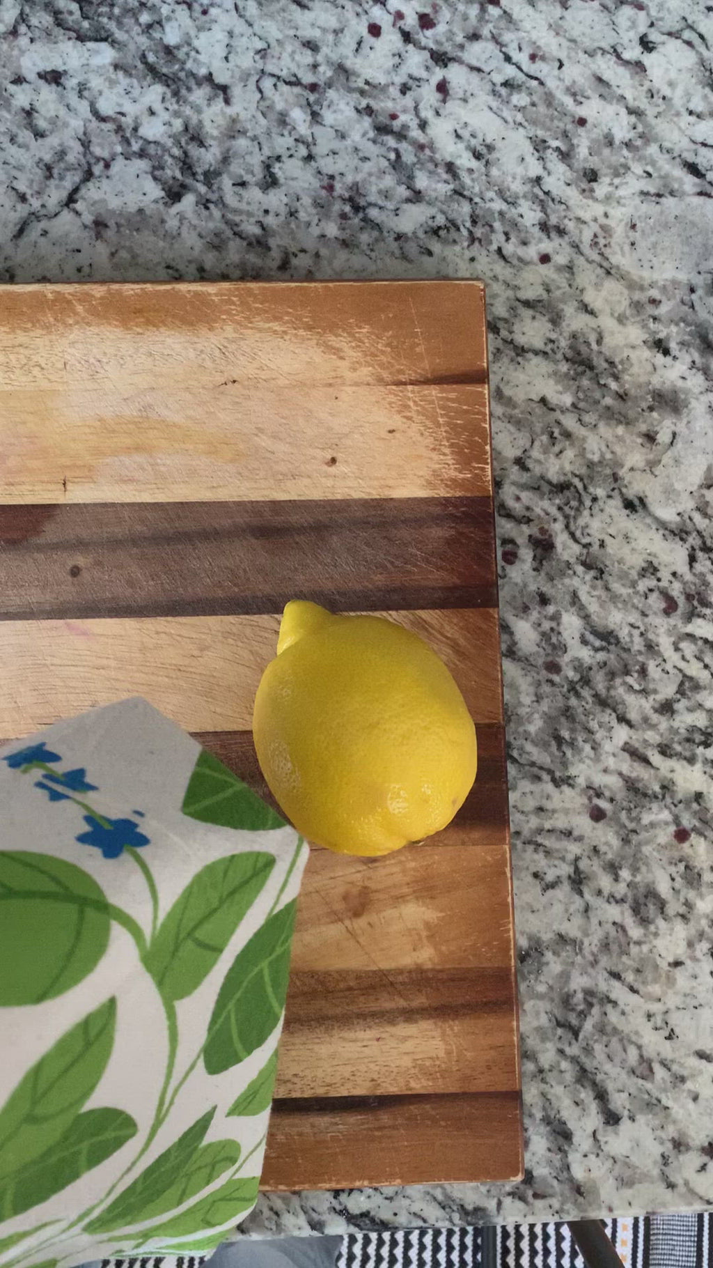 A demonstration video of a dish towel used to rub a lemon.