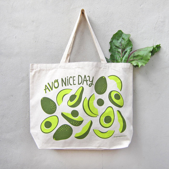 Avocado tote holding produce, hanging on a wall
