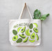 Avocado tote holding produce, hanging on a wall