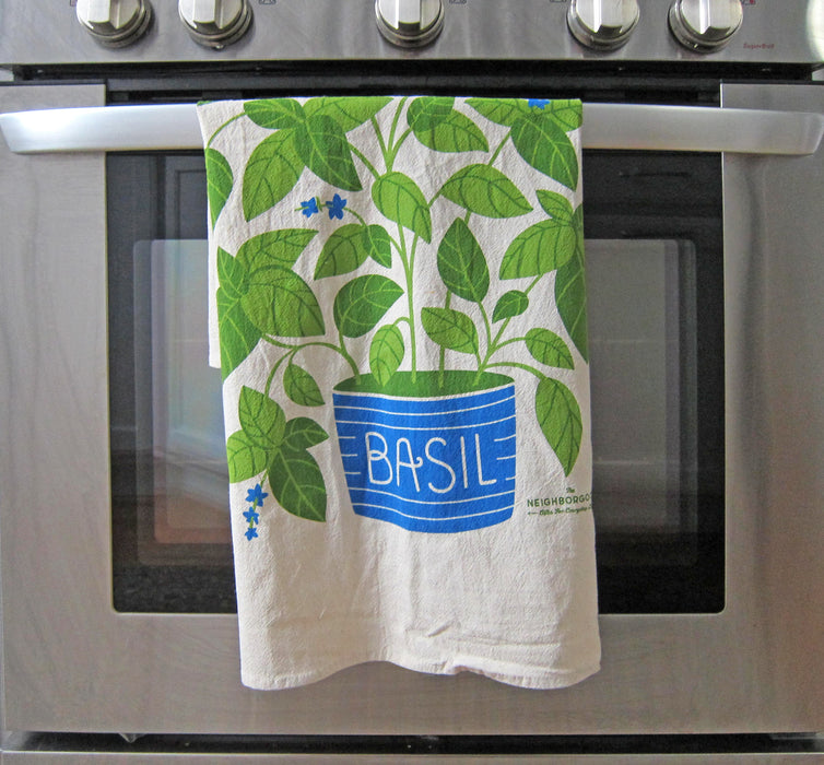 A Basil dish towel draped over an oven.