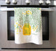 Screen-printed Dill dish towel draped over oven handle