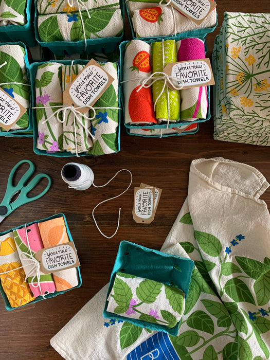 Packing process of fresh herbs dish towel set alongside other Neighborgoods dish towel sets
